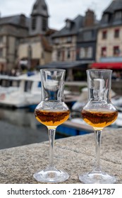 Tasting Of Apple Calvados Drink From Glasses In Old Honfleur Harbour With Boats And Old Houses On Background, Normandy, France