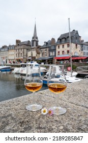 Tasting Of Apple Calvados Drink From Glasses In Old Honfleur Harbour With Boats And Old Houses On Background, Normandy, France