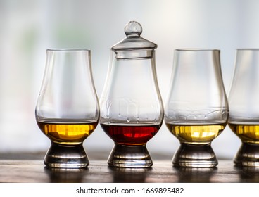 Tasting of flight of Scotch whisky from special tulip-shaped glasses on distillery in Scotland, UK close up