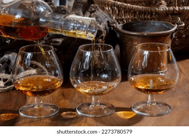 Tasting glasses of aged french cognac brandy alcoholic drink in old cellars of cognac-producing regions Champagne or Bois, France