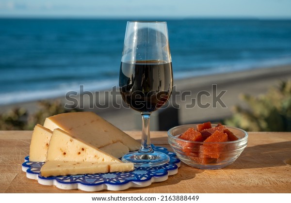 Tasting of sweet Spanish fortified Pedro\
Ximenez sherry wine with manchego cheese made with same sherry wine\
in El Puerto de Santa Maria, Andalusia,\
Spain