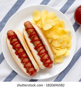 Tasty American Hot Dog With Potato Chips On A White Plate, Top View. Flat Lay, Overhead, From Above. Close-up.