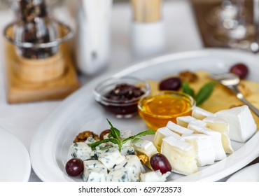 Tasty appetizer. Plate of Cheese on white plate at a restaurant