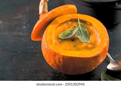 Tasty appetizing beautiful pumpkin soup in the whole pumpkin with bread and spices ready to eat on table Closeup - Powered by Shutterstock