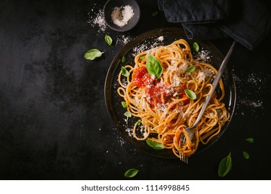 Tasty Appetizing Classic Italian Spaghetti Pasta With Tomato Sauce, Cheese Parmesan And Basil On Plate On Dark Table. View From Above, Top View