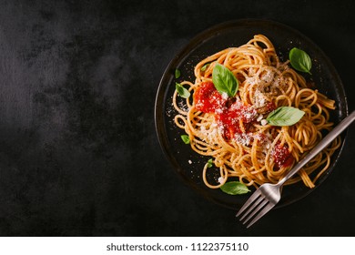 Tasty Appetizing Classic Italian Spaghetti Pasta With Tomato Sauce, Cheese Parmesan And Basil On Plate On Dark Table. View From Above, Horizontal