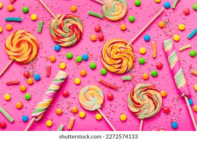 Tasty appetizing Party Accessories Happy Birthday Sweet. Different types of candies on colored background, copy space. Colorful birthday party background.