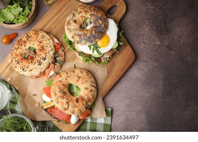 Tasty bagel sandwiches on brown table, flat lay. Space for text - Powered by Shutterstock