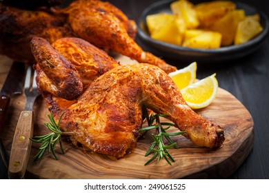 Tasty baked chicken with herbs and lemon - Shutterstock ID 249061525