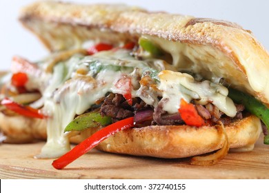 Tasty beef steak sandwich with onions, mushroom and melted provolone cheese in a ciabatta