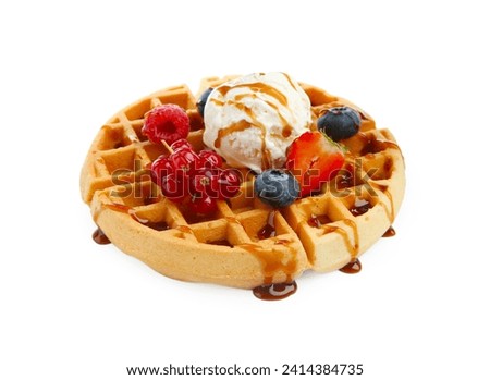 Tasty Belgian waffle with ice cream, berries and caramel syrup on white background