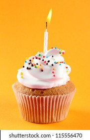 Tasty Birthday Cupcake With Candle, On Orange Background