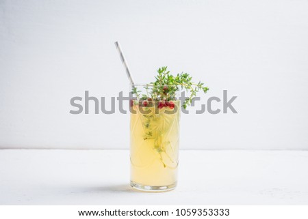 Tasty bitter cocktail with thyme in martini glass. Selective focus.
