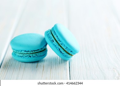 Tasty Blue Macarons On A Blue Wooden Table