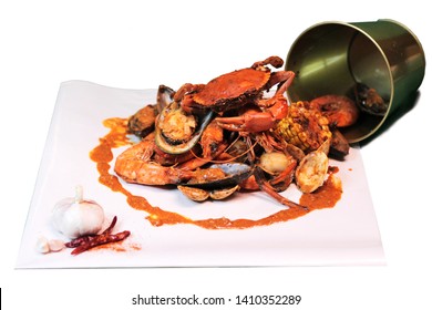 Tasty Boiling Seafood In The Bucket With Crab Shrimp Prawn Mussel Clam Corn On The Cob And Sauce On White Background