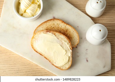 Tasty Bread With Butter Served For Breakfast On Wooden Table, Top View