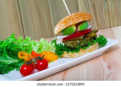 Tasty Burger With Vegan Cutlet, Lettuce, Avocado Onion Tomato Pickled Cucumbers