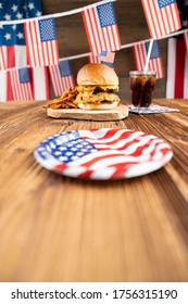 Tasty Burgers On Rustic Wooden Table. American Decorations. 4th Of July Celebration Concept.