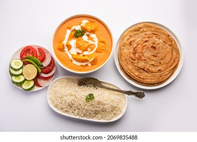 Tasty Butter Chicken Curry Dish From Indian Cuisine Served With Rice And Paratha