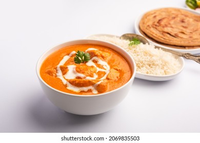 Tasty Butter Chicken Curry Dish From Indian Cuisine Served With Rice And Paratha