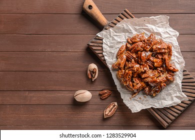 Tasty Candied Pecan Nuts On Wooden Table