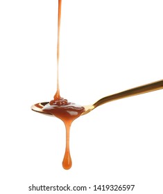 Tasty Caramel Sauce Pouring Into Spoon Isolated On White