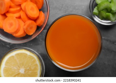 Tasty Carrot Juice And Ingredients On Black Marble Table, Flat Lay