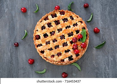 Tasty cherry pie on gray table