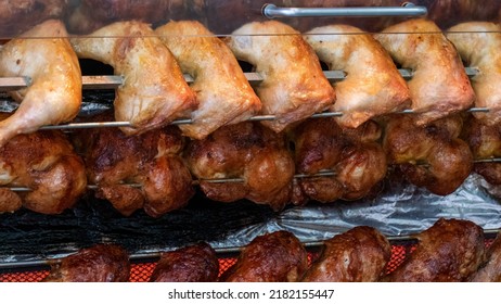 Tasty Chicken, Chicken Legs And Turkey Drumsticks On A Rotisserie In The Restaurant