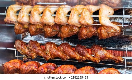 Tasty Chicken, Chicken Legs And Turkey Drumsticks On A Rotisserie In The Restaurant