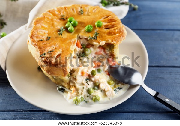 Tasty chicken\
pot pie with green peas on\
plate