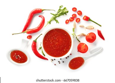 Tasty Chili Sauce In Bowl And Ingredients On White Background