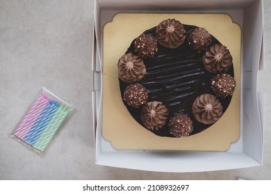 Tasty Chocolate Cake In Box And Candle For Happy Birthday