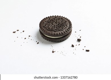 Tasty Chocolate Cookie And Crumbs On White Background