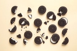 Tasty Chocolate Cookies With Cream On Color Background, Flat Lay