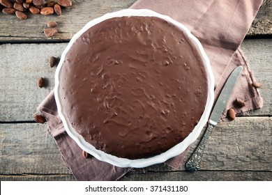 Tasty Chocolate Frosting Cake On Wooden Table