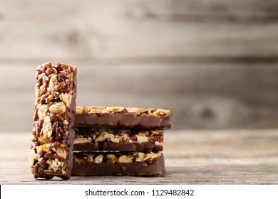 Tasty Chocolate Granola Bars On Wooden Table