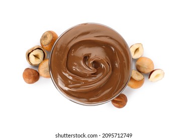 Tasty chocolate hazelnut spread and nuts on white background, top view
