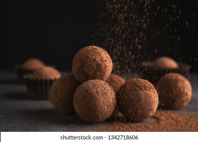 Tasty Chocolate Truffles Powdered With Cocoa On Table