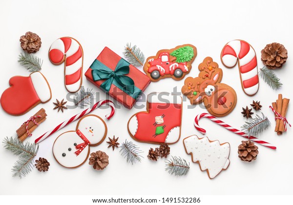 Tasty\
Christmas cookies with gift on white\
background