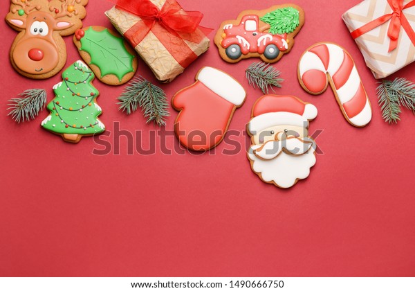 Tasty\
Christmas cookies with gifts on color\
background