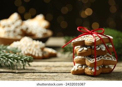 Tasty Christmas cookies with icing on wooden table against blurred lights. Space for text - Powered by Shutterstock