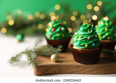 Tasty Christmas cupcakes on wooden board, closeup. Space for text - Powered by Shutterstock