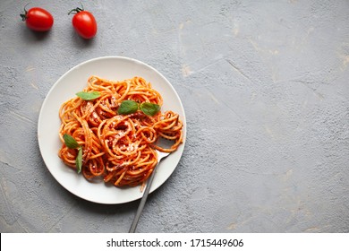 Tasty classic italian spaghetti pasta with tomato sauce, cheese parmesan and basil on plate, copy space - Powered by Shutterstock