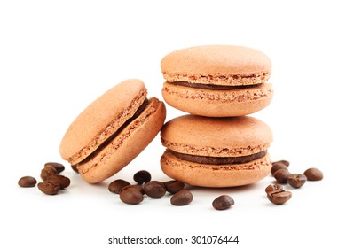 Tasty coffee macarons with coffee beans isolated on white