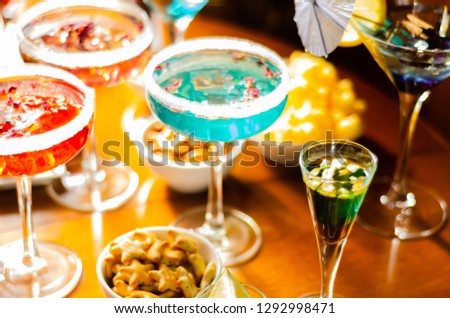 Tasty and colorful drinks based on various alcohols, syrups and liqueurs, unique effect of the bartender's work, party night