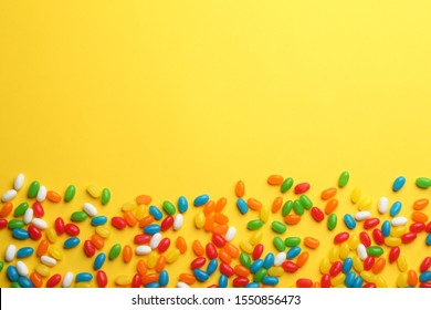 Tasty colorful jelly beans on yellow background, flat lay. Space for text - Powered by Shutterstock