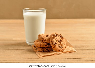 Tasty cookies with chocolate chips and glass of milk on table - Powered by Shutterstock