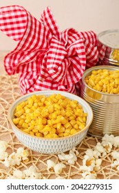 Tasty corn with popcorn and bundle bag on color background. Festa Junina (June Festival) celebration