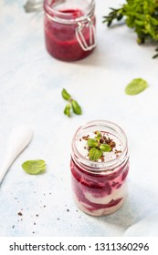 Tasty Cottage Cheese Parfait With Raspberry Sauce And Mint In A Glass Jar. Diet Dessert. Light Grey Stone Concrete Background. Copy Space.